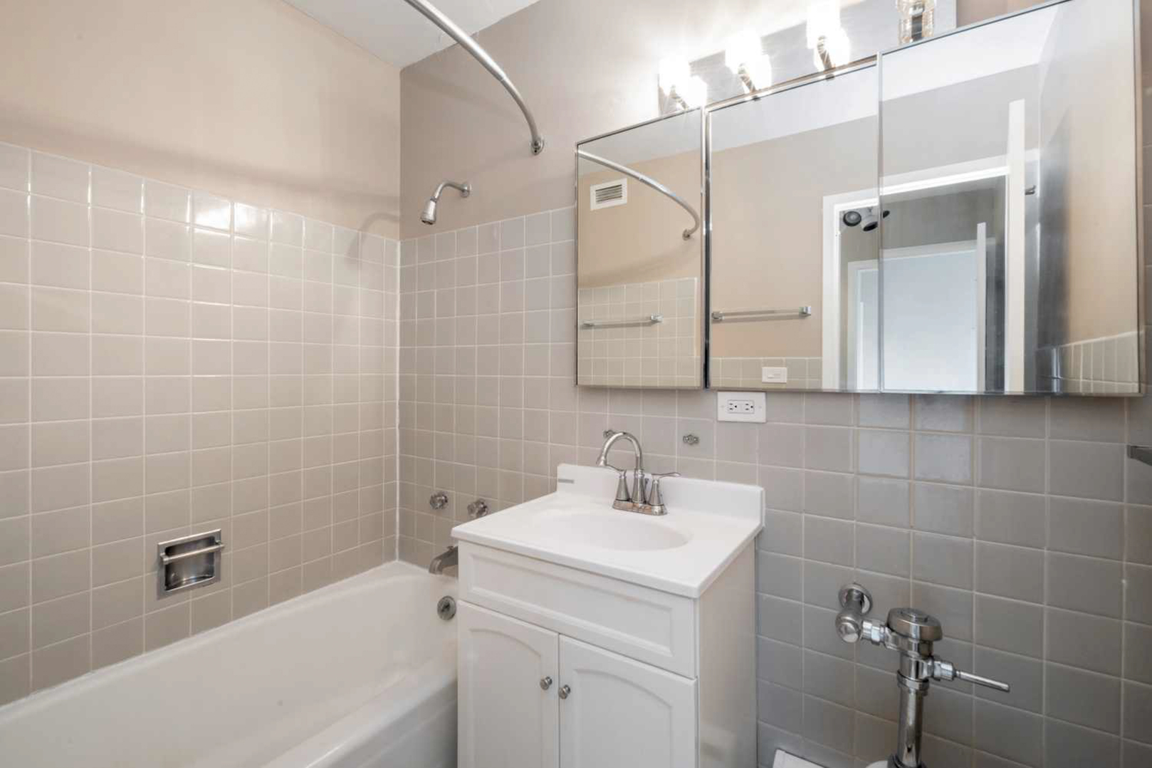 5757 North Sheridan Road, Unit 4E Chicago, IL 60660 - Photo 10 of 11 a bathroom with a sink a toilet and shower