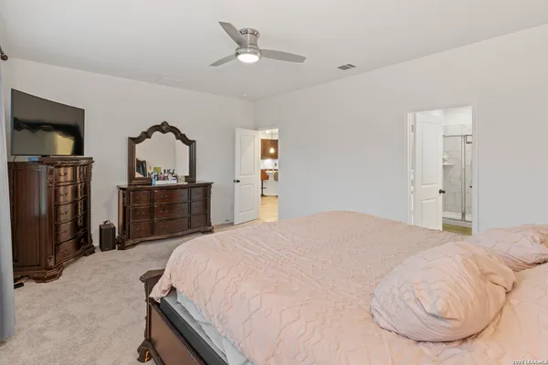 a bedroom with a bed and a television