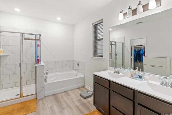 a spacious bathroom with a bathtub sink and mirror