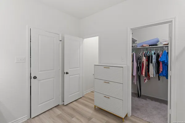 a view of walk in closet with clothes