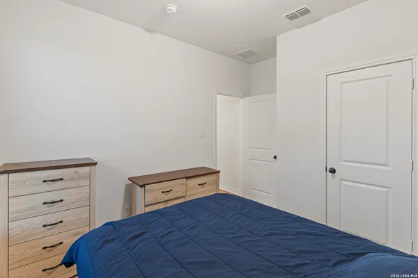a bedroom with a bed and a dresser