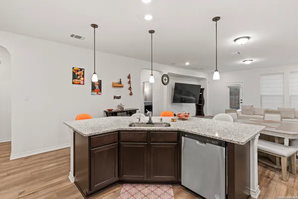 a kitchen with a sink a counter and chairs