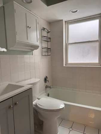 a bathroom with a sink a toilet and vanity