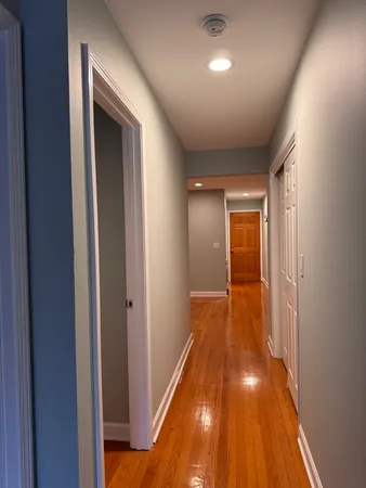 a view of a hallway with wooden floor