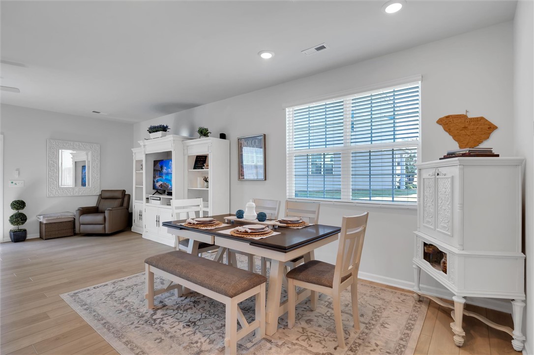 453 Bee Cv Way Pendleton, SC 29670 - Photo 7 of 25 An inviting dining area flows seamlessly into the living space, perfect for entertaining.