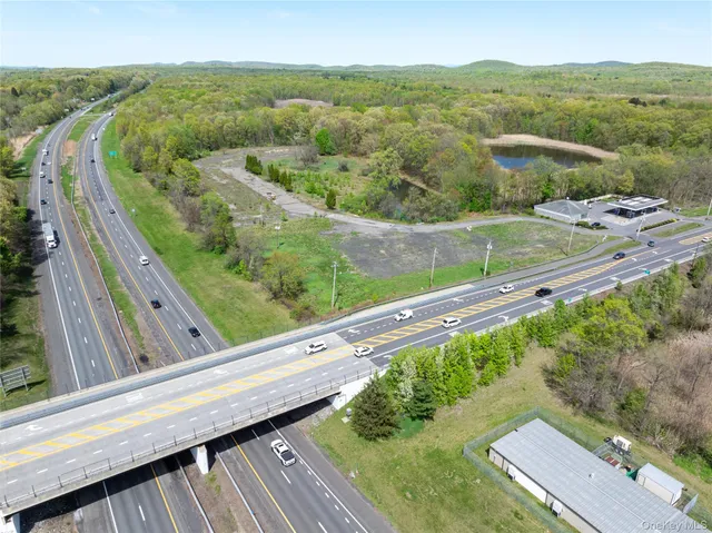 a view of a city from a balcony with a yard