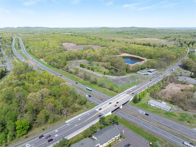 an aerial view of residential houses with outdoor space and street view