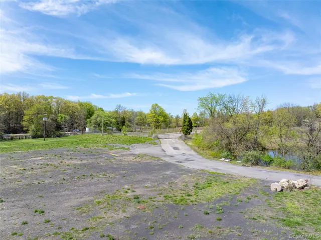 a view of a big yard with large trees