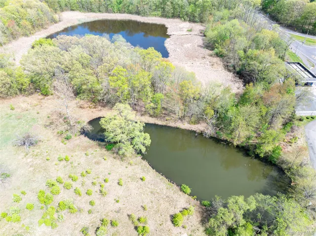 a view of a dirt road with a building in the background