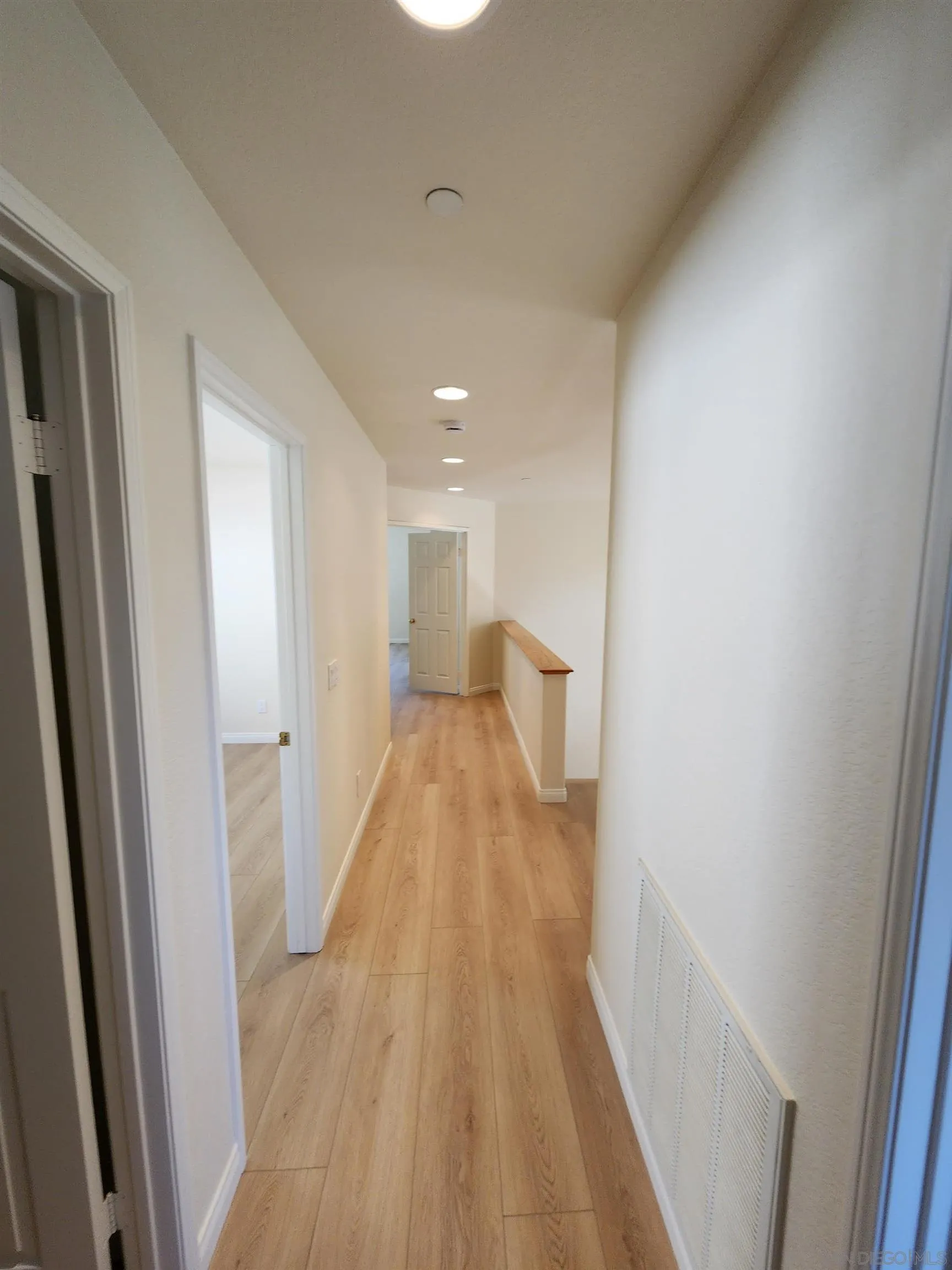 10552 Canberra Court San Diego, CA 92127 - Photo 17 of 25 a view of a hallway with wooden floor