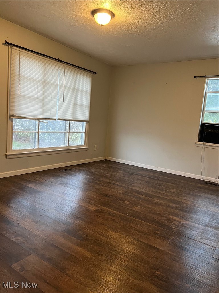 4877 Wake Robin Road Mentor, OH 44060 - Photo 3 of 7 Living room with a textured ceiling, plenty of natural light, and dark hardwood / wood-style floors