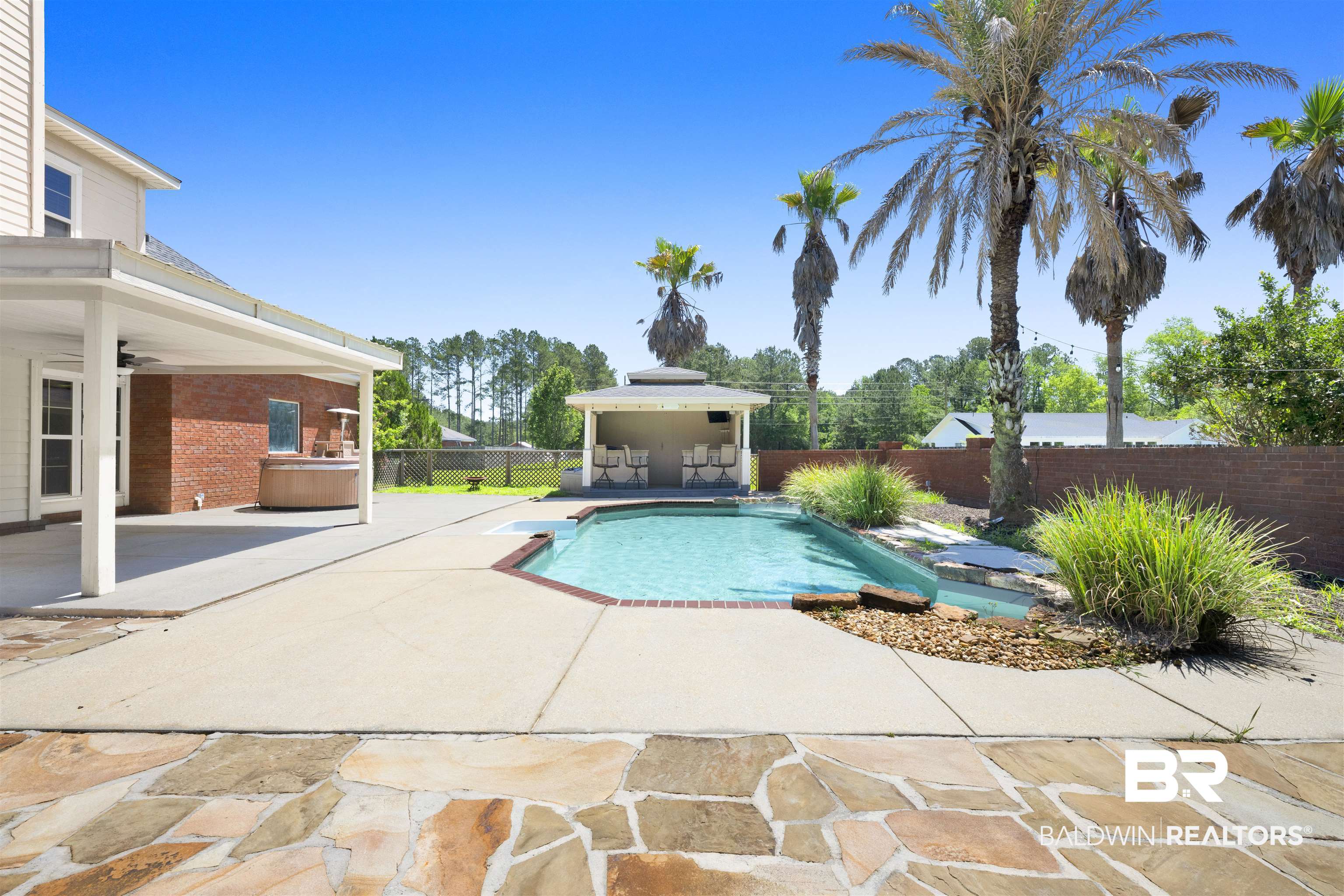 12944 Anna's Way Stapleton, AL 36578 - Photo 22 of 64 Backyard oasis featuring a swimming pool with integrated spa, adjacent covered patio, and a separate cabana structure