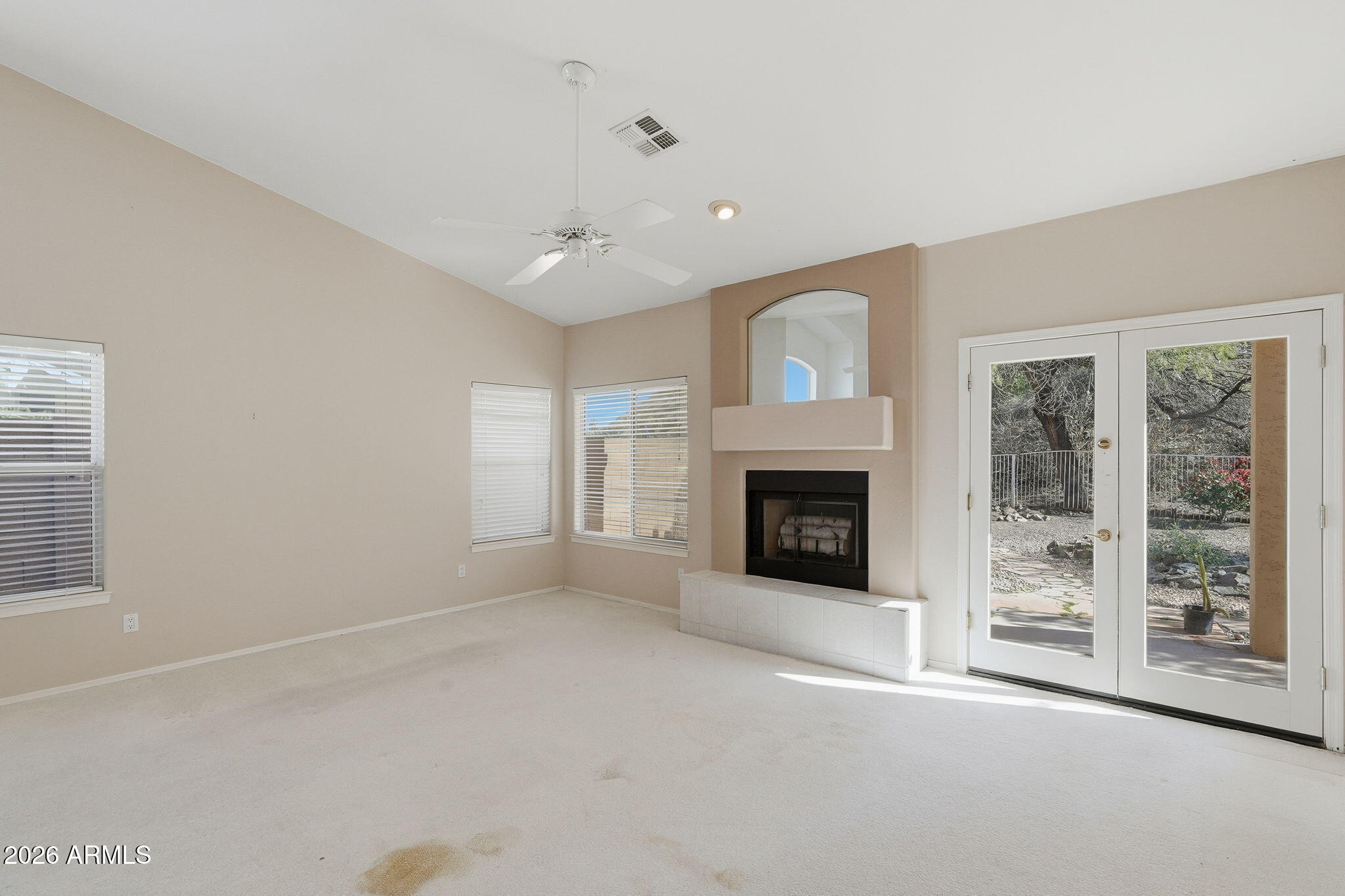 16651 South 18th Way Phoenix, AZ 85048 - Photo 21 of 43 a view of an empty room with a fireplace and a window