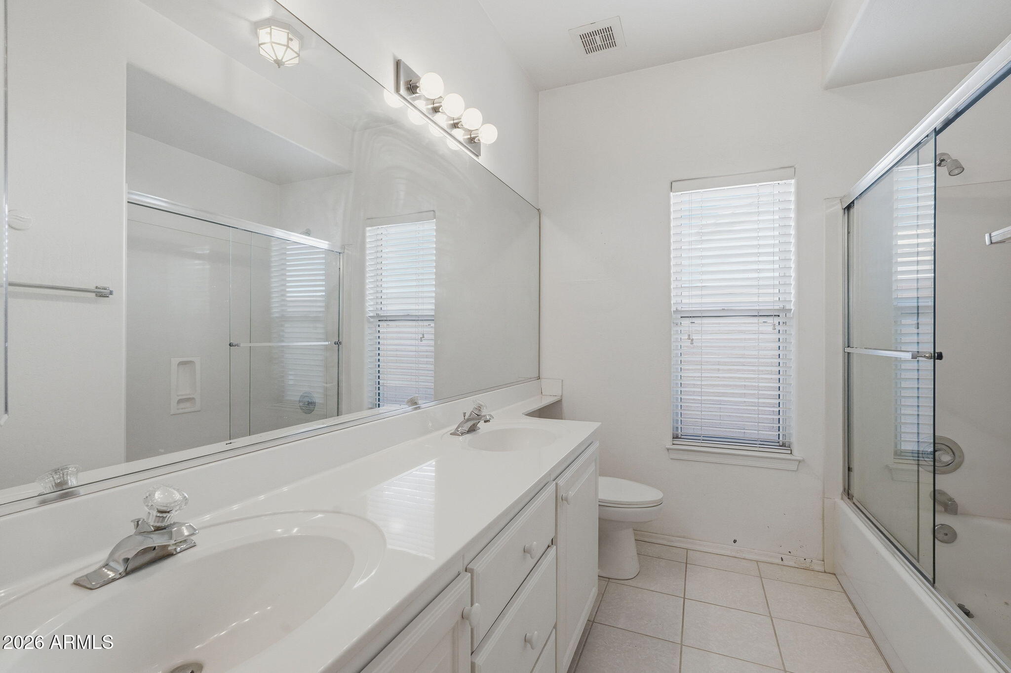 16651 South 18th Way Phoenix, AZ 85048 - Photo 31 of 43 a bathroom with a double vanity sink toilet and shower