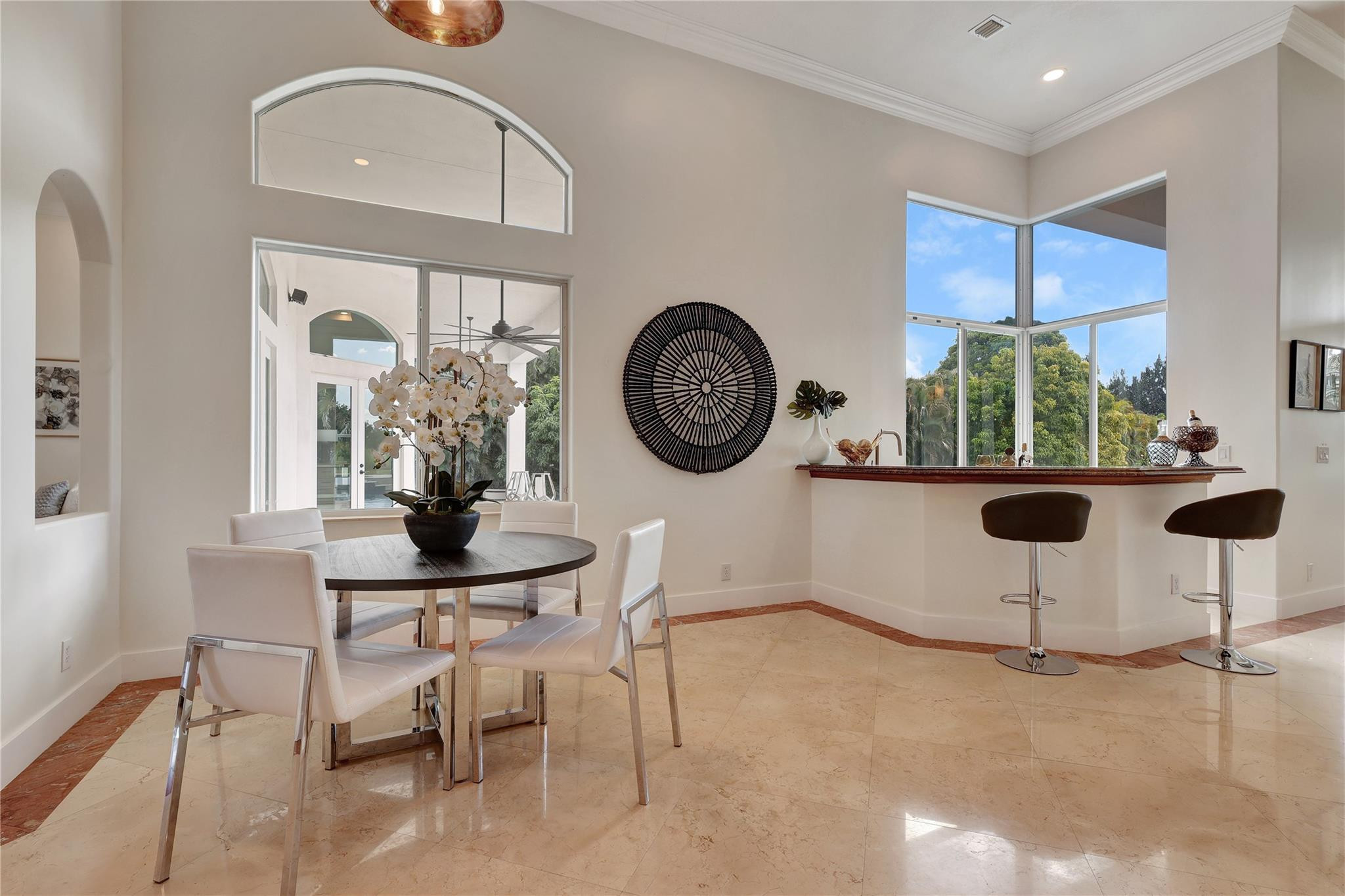 Undisclosed Address Southwest Ranches, FL 33332 - Photo 17 of 54 a view of a kitchen with a dining table and chairs