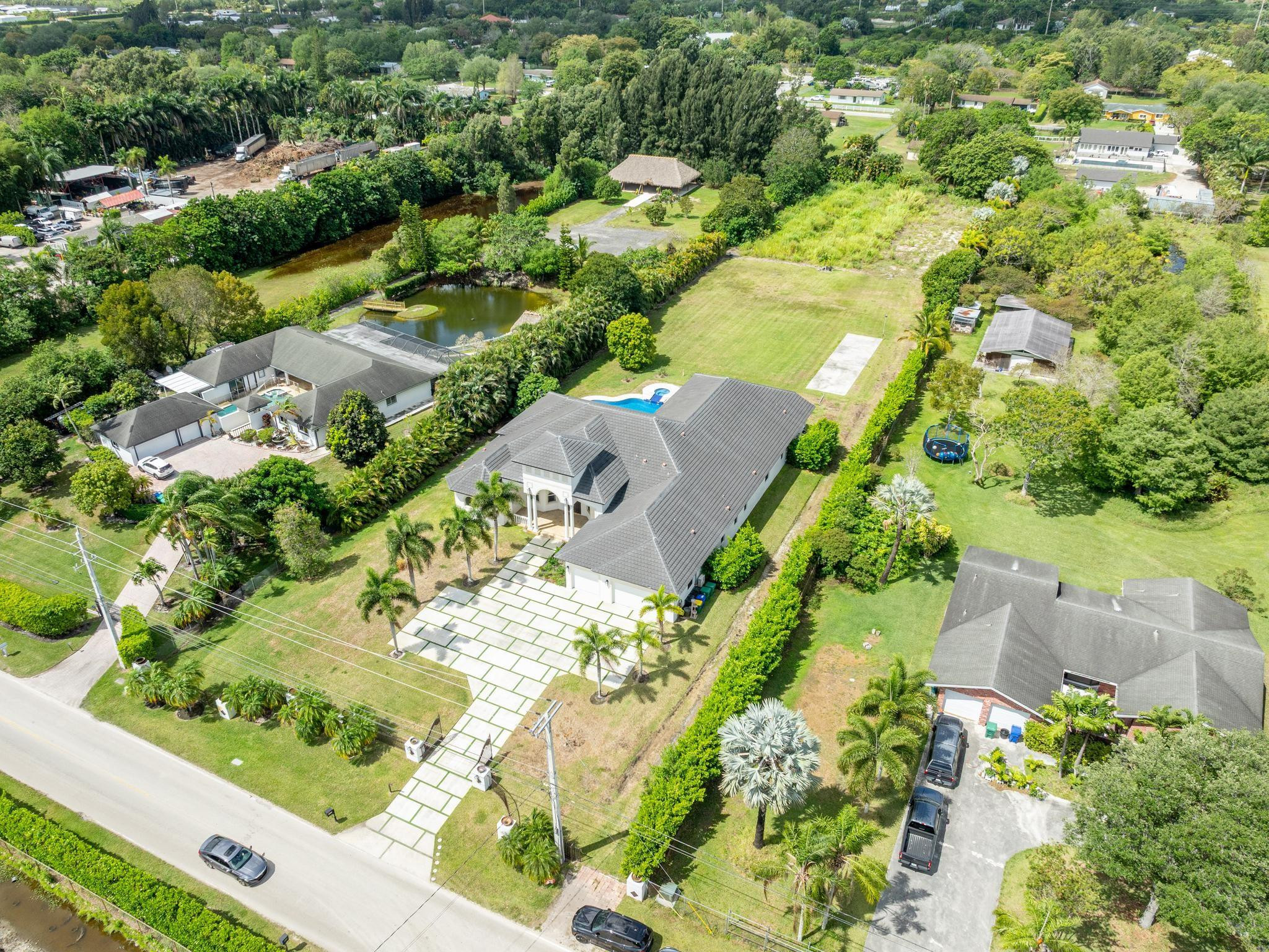 Undisclosed Address Southwest Ranches, FL 33332 - Photo 2 of 54 an aerial view of residential houses with outdoor space