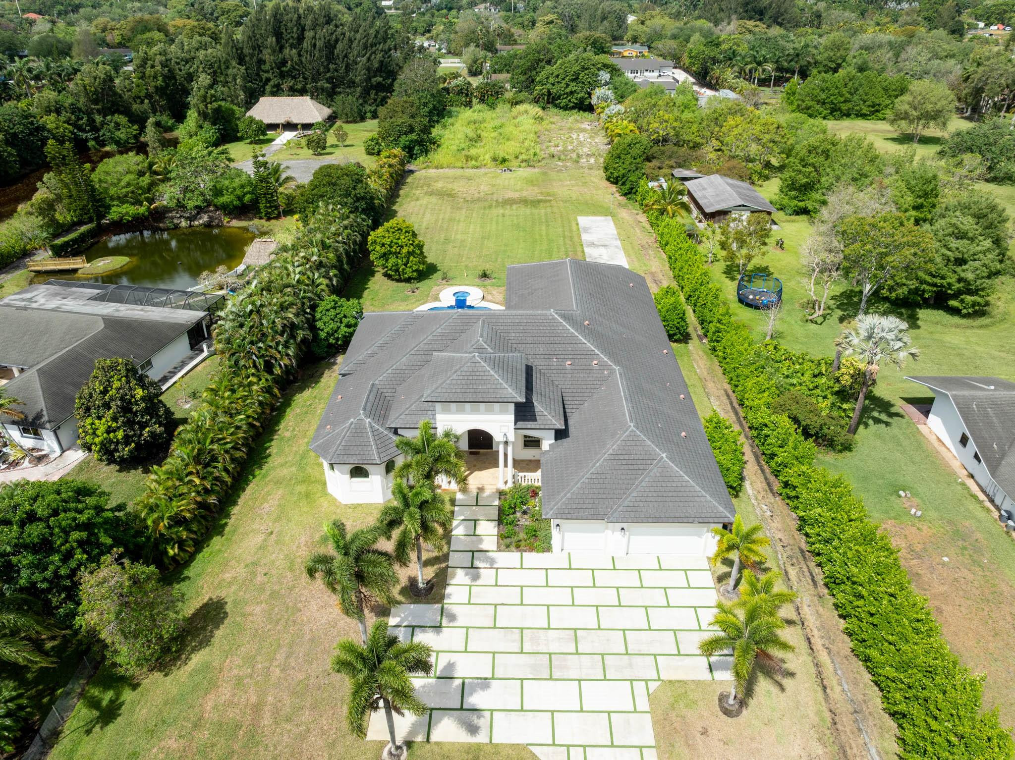 Undisclosed Address Southwest Ranches, FL 33332 - Photo 4 of 54 an aerial view of a house with a yard