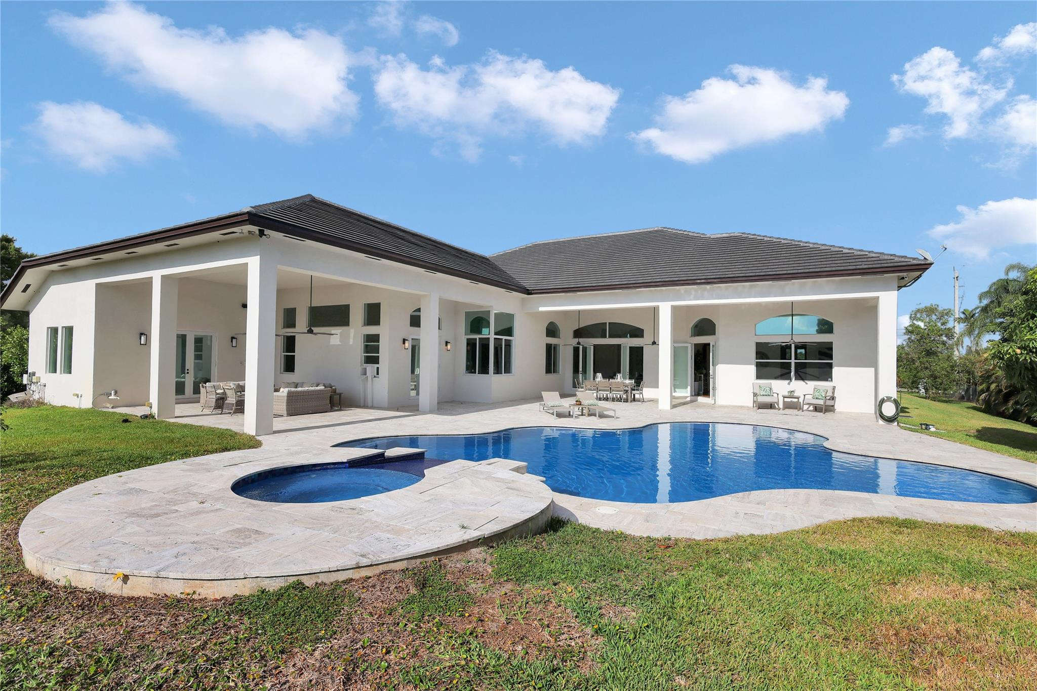 Undisclosed Address Southwest Ranches, FL 33332 - Photo 43 of 54 a front view of a house with swimming pool having outdoor seating
