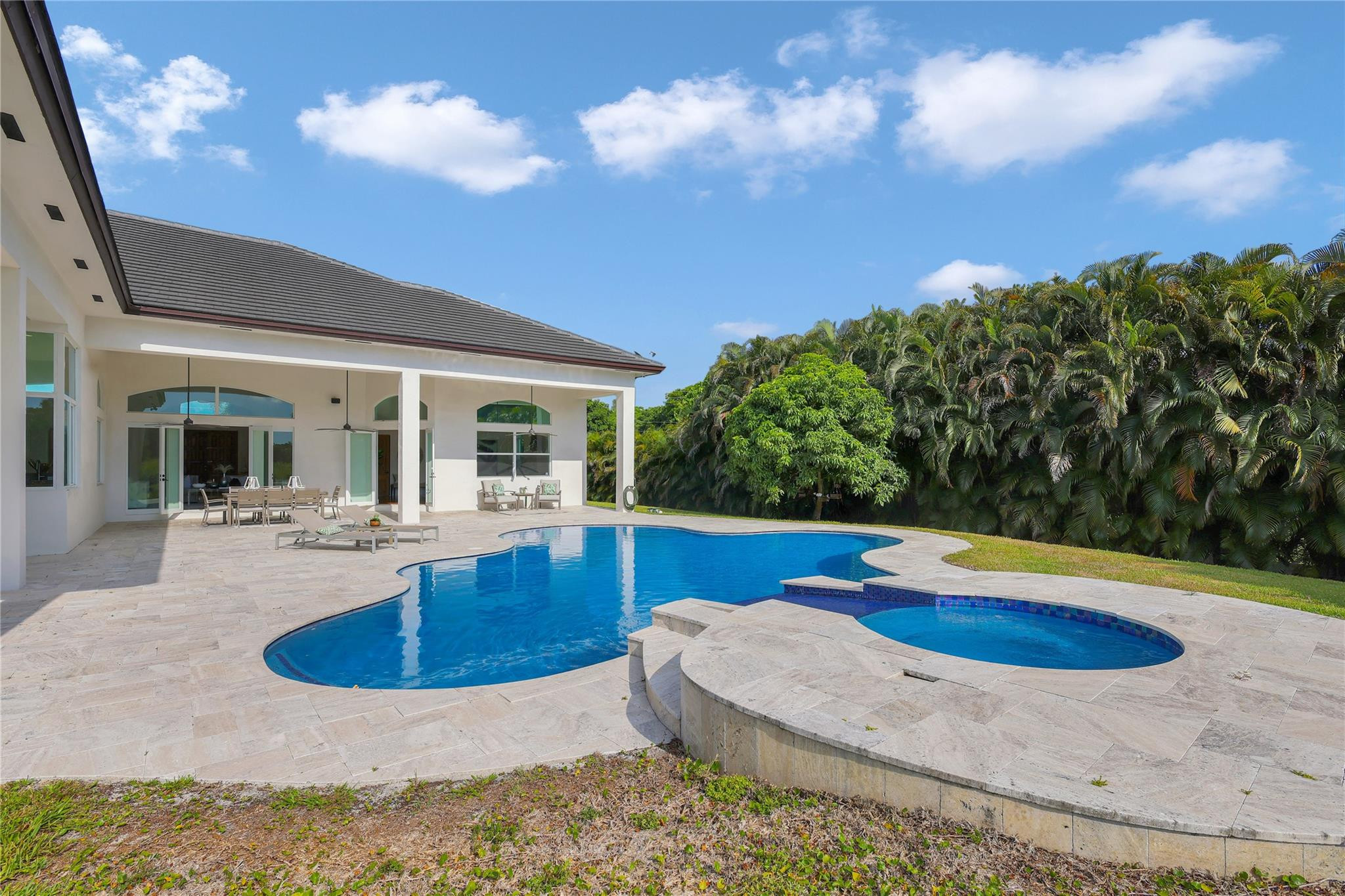 Undisclosed Address Southwest Ranches, FL 33332 - Photo 44 of 54 a view of a house with swimming pool and sitting area