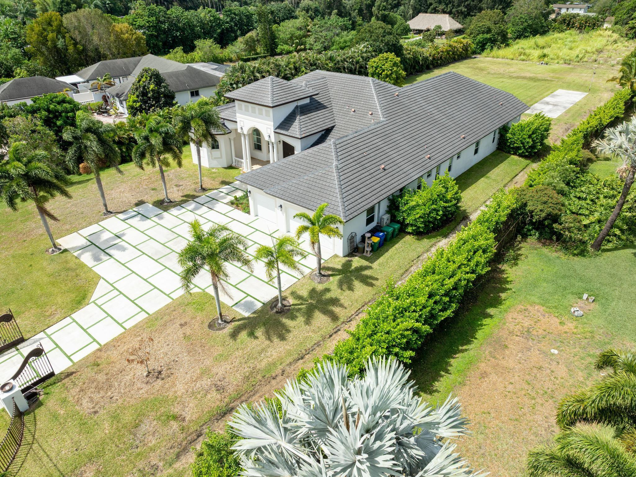 Undisclosed Address Southwest Ranches, FL 33332 - Photo 49 of 54 an aerial view of residential houses with outdoor space and trees all around