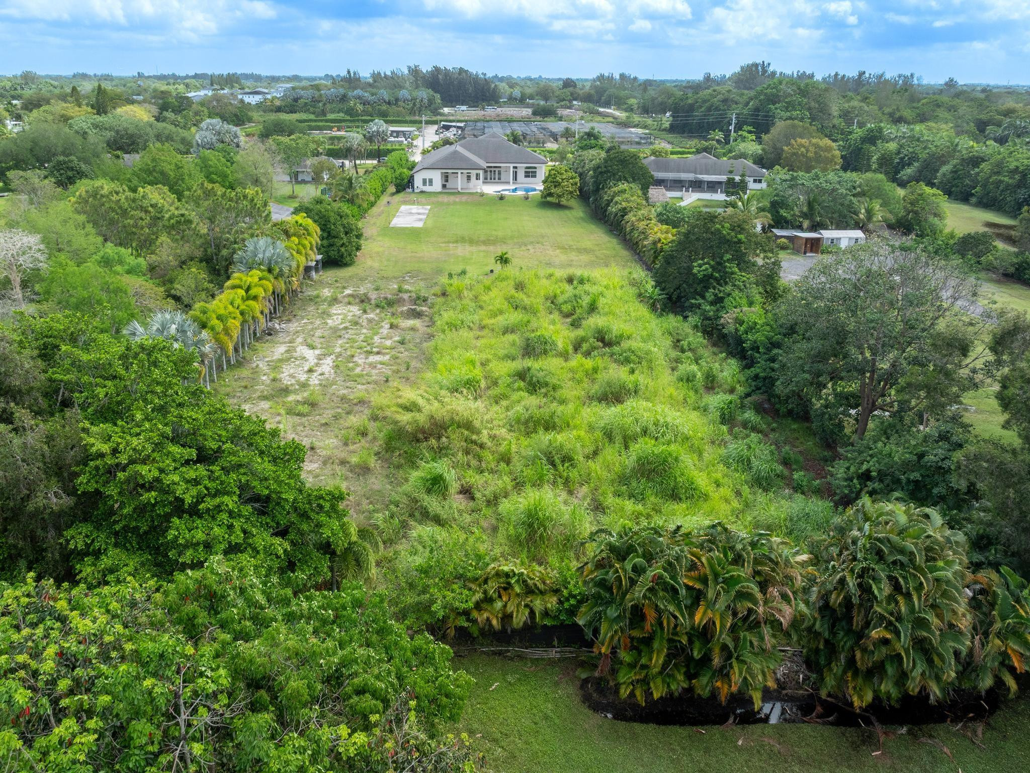 Undisclosed Address Southwest Ranches, FL 33332 - Photo 51 of 54 an aerial view of residential houses with outdoor space and trees
