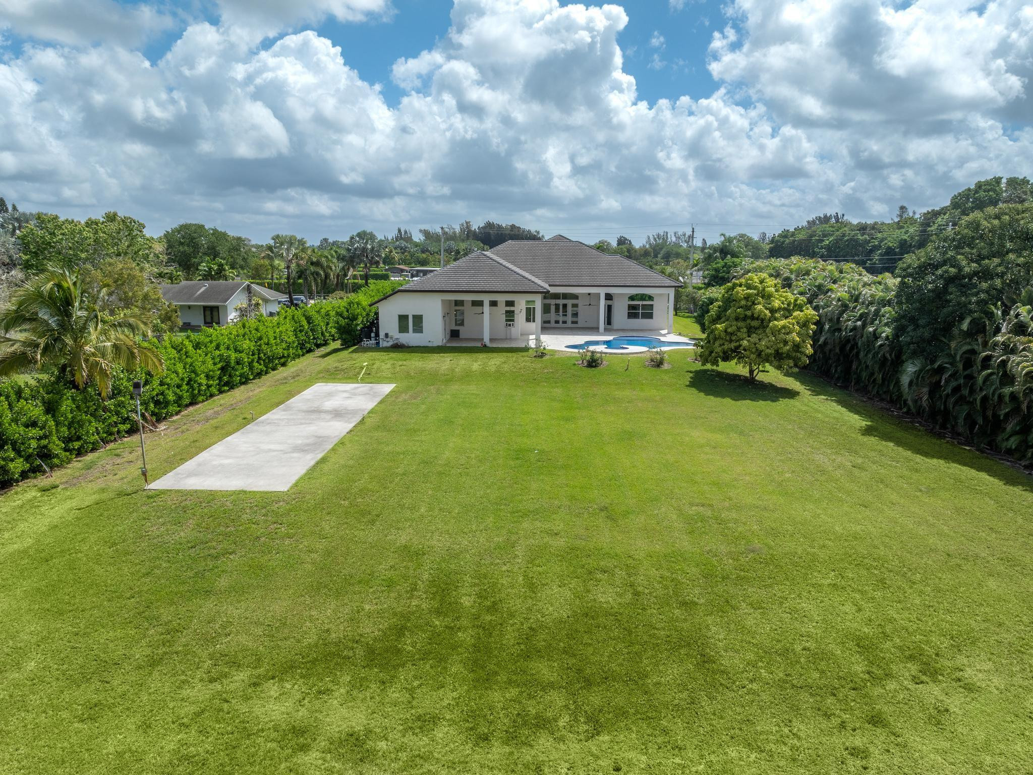 Undisclosed Address Southwest Ranches, FL 33332 - Photo 7 of 54 a view of a house with a big yard plants and large trees