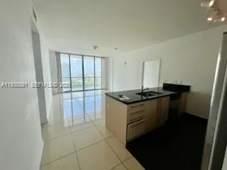 a kitchen with a sink and a refrigerator