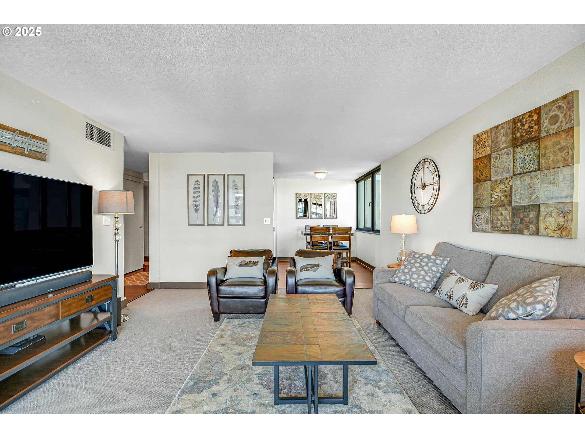 255 Southwest Harrison Street, Unit 17F Portland, OR 97201 - Photo 12 of 31 a living room with furniture and a flat screen tv