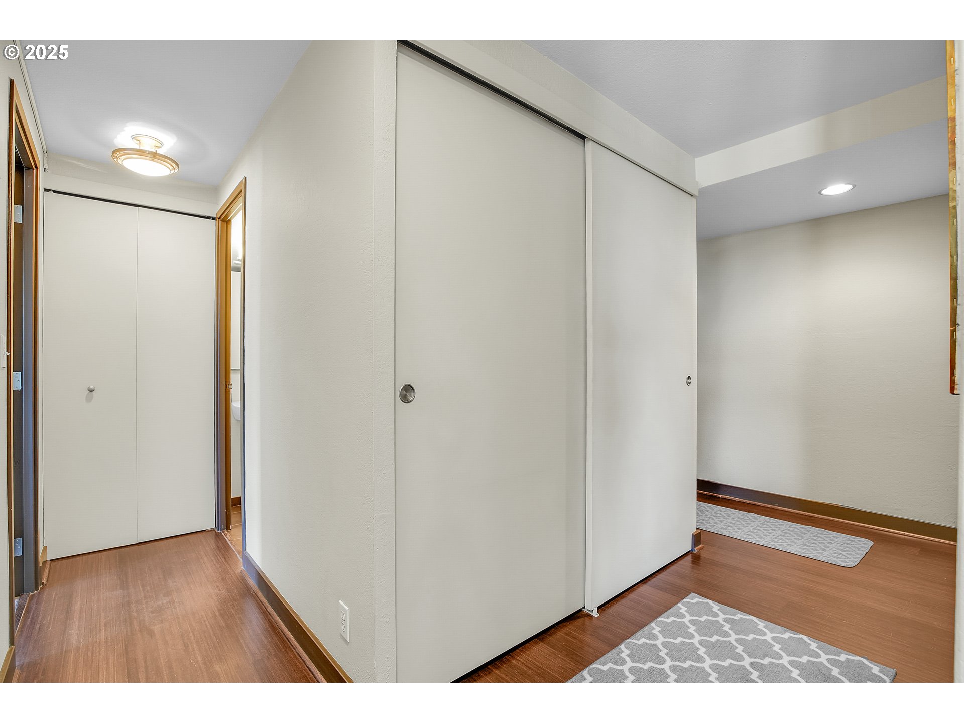 255 Southwest Harrison Street, Unit 17F Portland, OR 97201 - Photo 13 of 31 a view of an empty room with wooden floor and closet