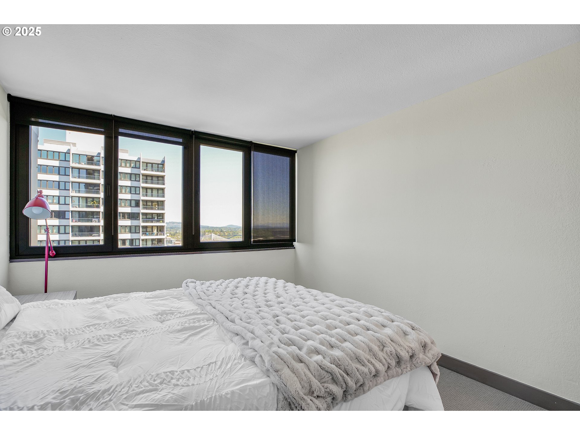 255 Southwest Harrison Street, Unit 17F Portland, OR 97201 - Photo 15 of 31 a bedroom with a large bed and a large window