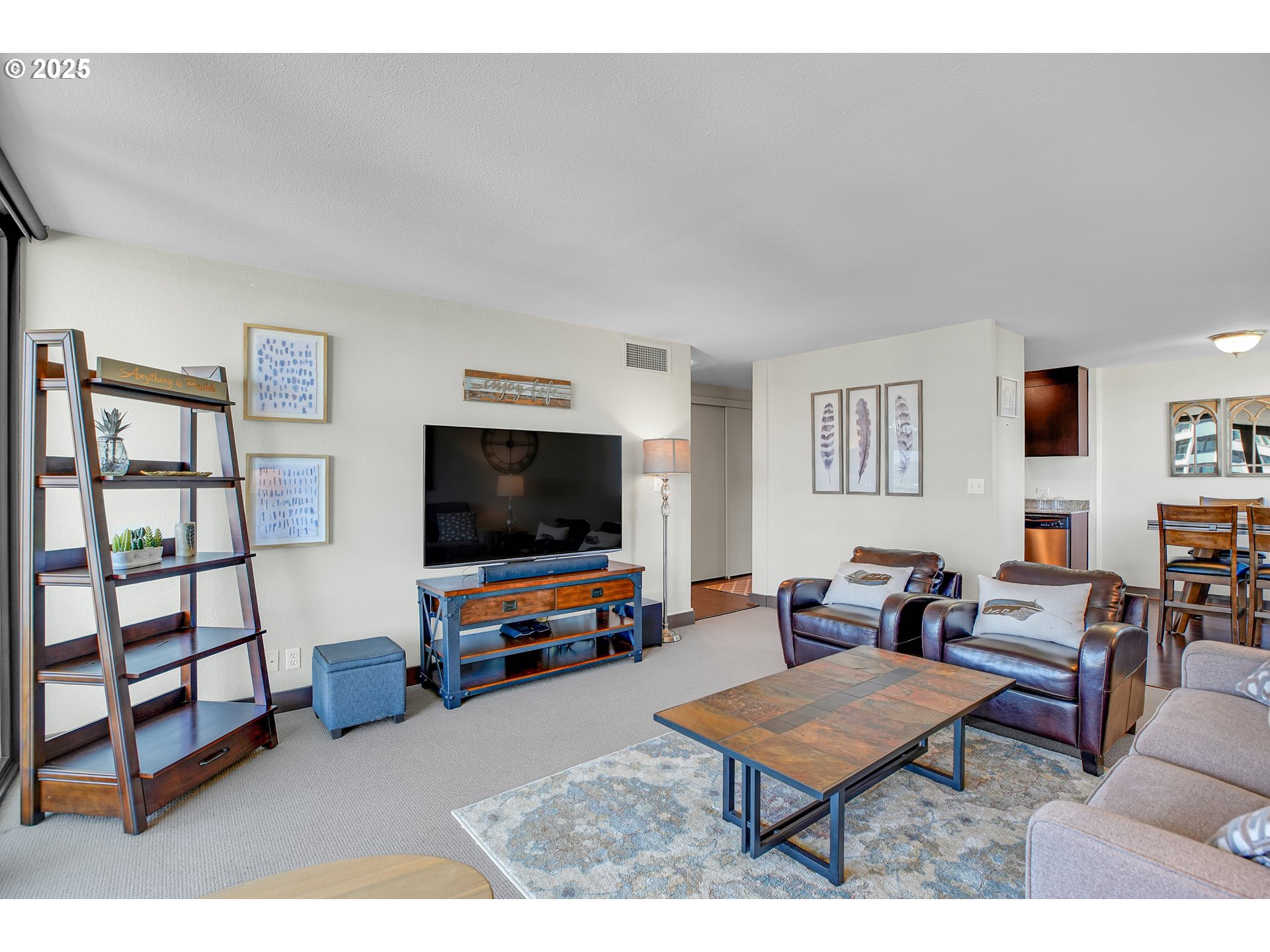 255 Southwest Harrison Street, Unit 17F Portland, OR 97201 - Photo 5 of 31 a living room with furniture and a flat screen tv