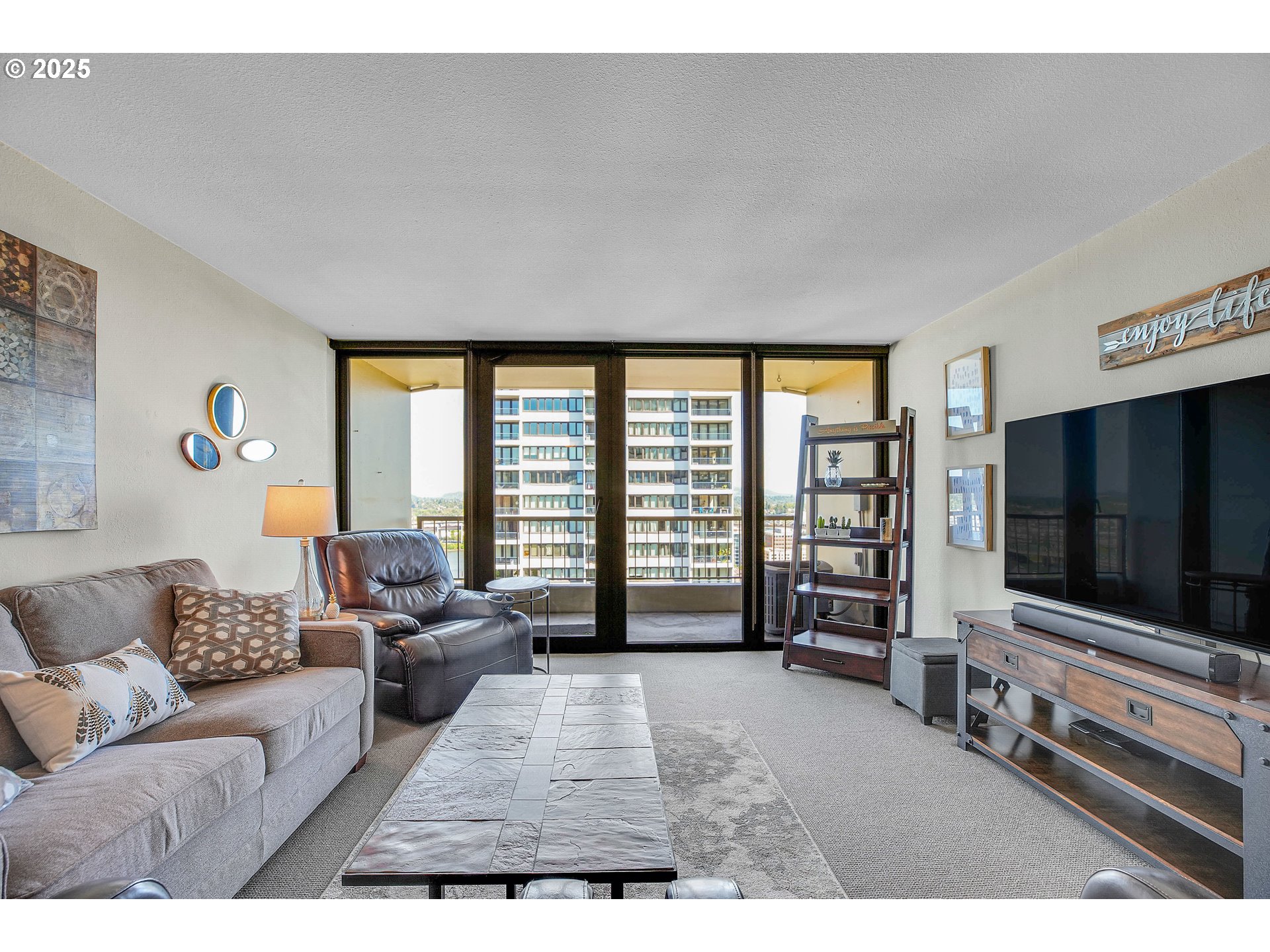 255 Southwest Harrison Street, Unit 17F Portland, OR 97201 - Photo 9 of 31 a living room with furniture and a flat screen tv