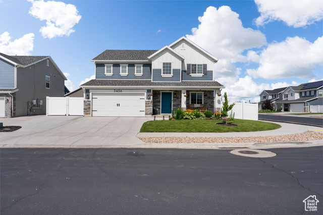 3456 South Linden Way Syracuse, UT 84075 - Photo 49 of 50 View of front of property with driveway, stone siding, an attached garage, and board and batten siding
