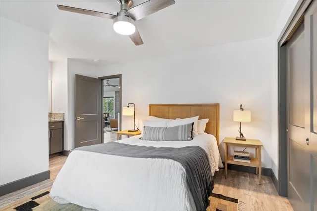 a bedroom with a bed and a chandelier