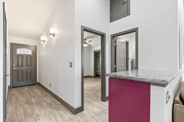 a view of a hallway with cabinet and mirror