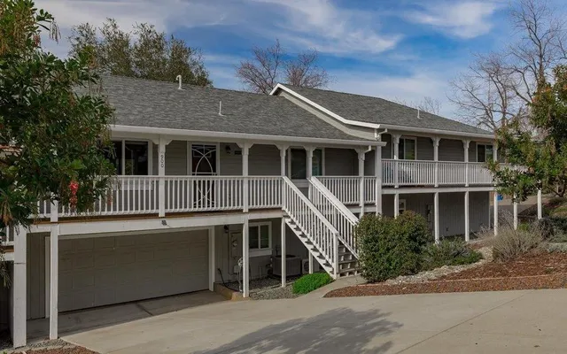 a front view of a house with a garden
