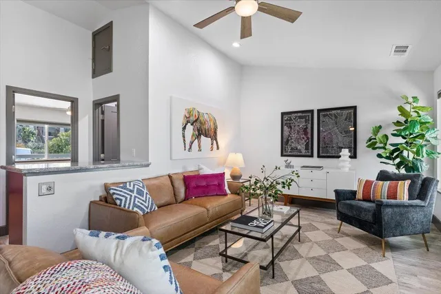 a living room with furniture and a potted plant