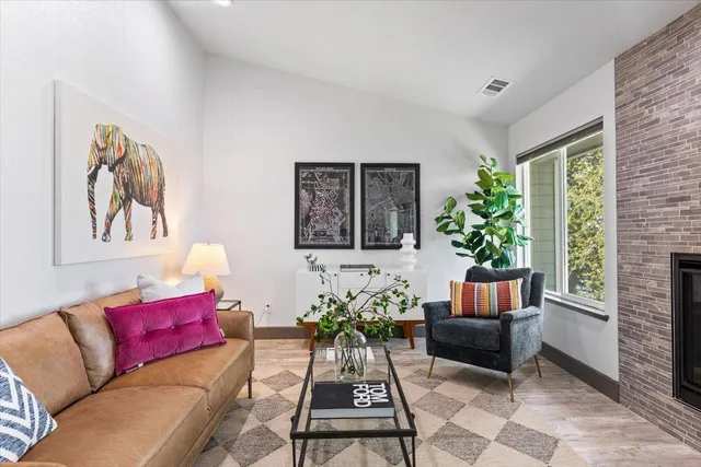 a living room with furniture and a potted plant