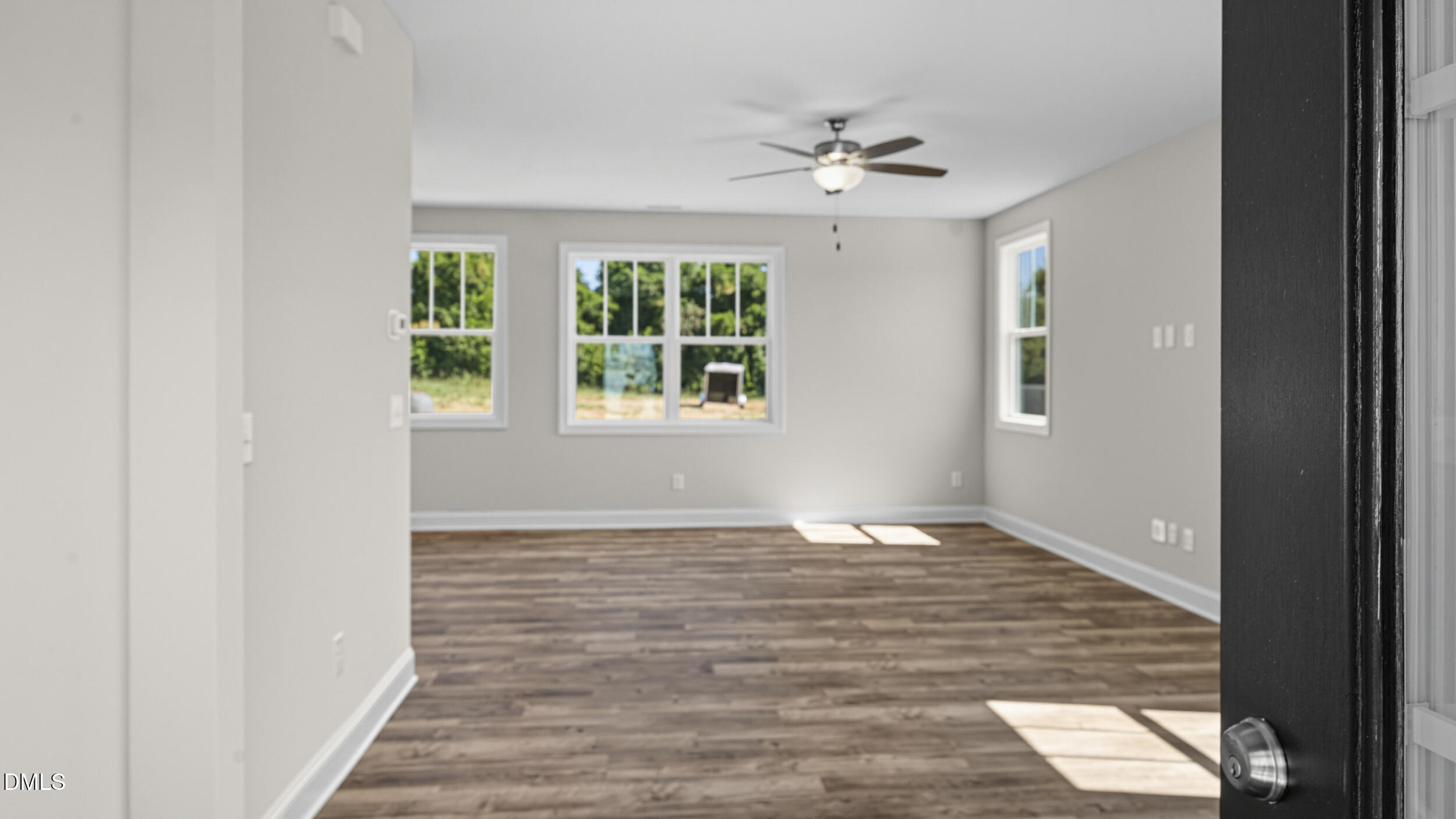 4105 Ralph Holt Court Snow Camp, NC 27349 - Photo 5 of 35 a view of an empty room with wooden floor and a window