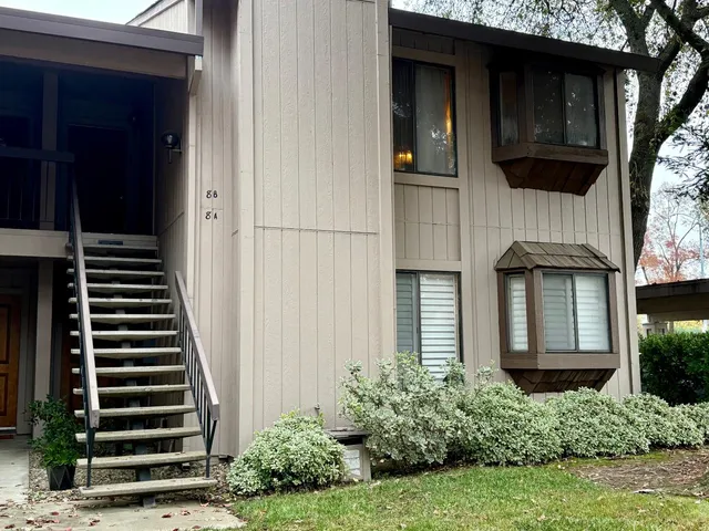 a front view of a house with a garden