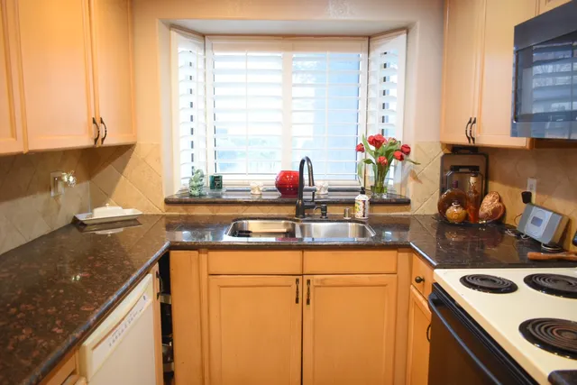 a kitchen with a sink stove and cabinets