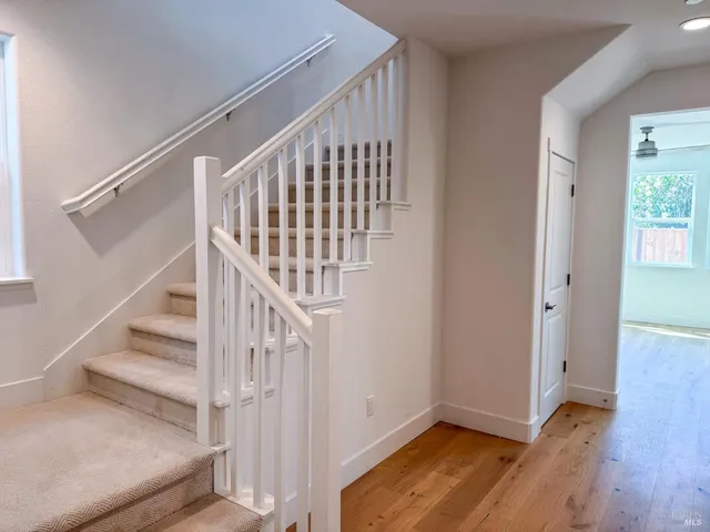 a view of entryway with wooden floor and stairs
