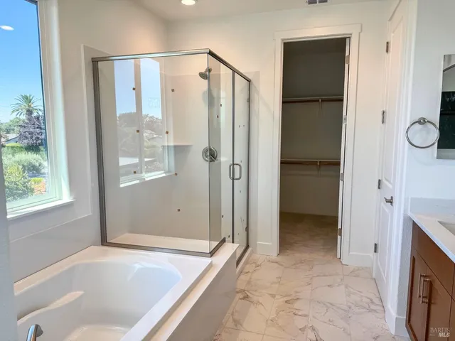 a bathroom with a tub shower and sink