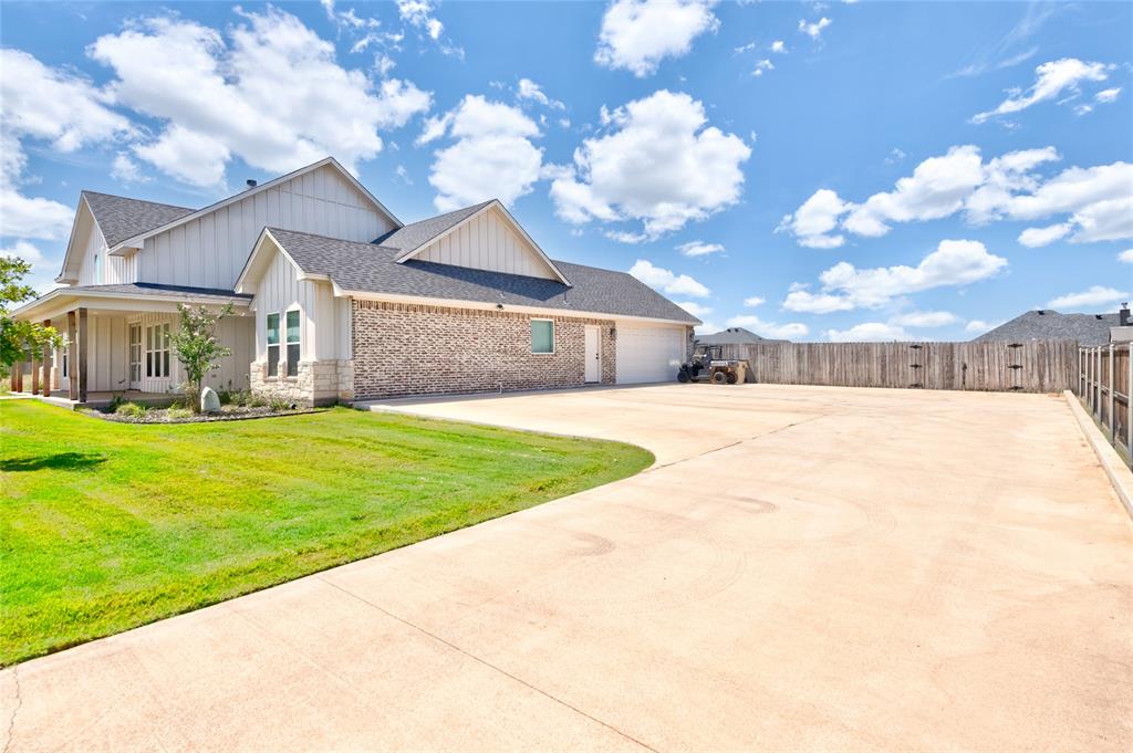 120 Long Ranger Road Abilene, TX 79602 - Photo 23 of 23 Spacious concrete driveway accommodating multiple vehicles, bordered by a green lawn