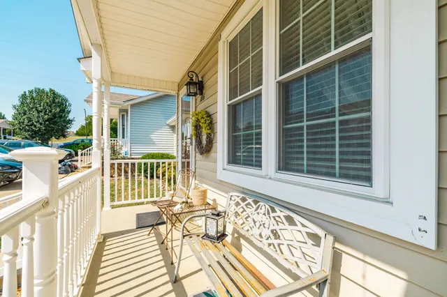 a view of a patio with table and chairs with wooden floor and fence