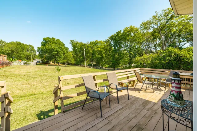 a view of a house with a yard and sitting area