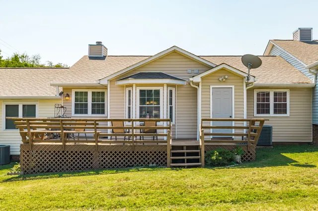 a view of a hallway with wooden floor and entryway