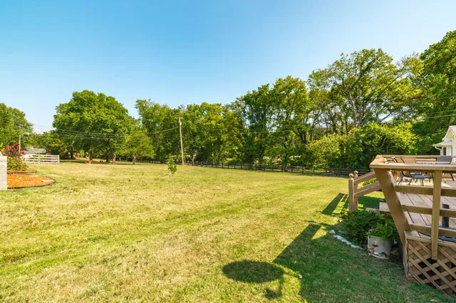 a living room with furniture a flat screen tv and a floor to ceiling window