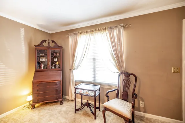 a bedroom with a bed and a dresser in it