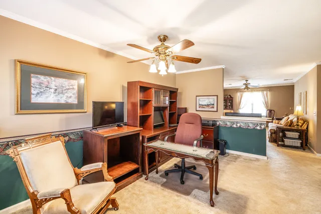a bedroom with a bed and a potted plant